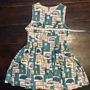 Fan and bottle above the knee length dress